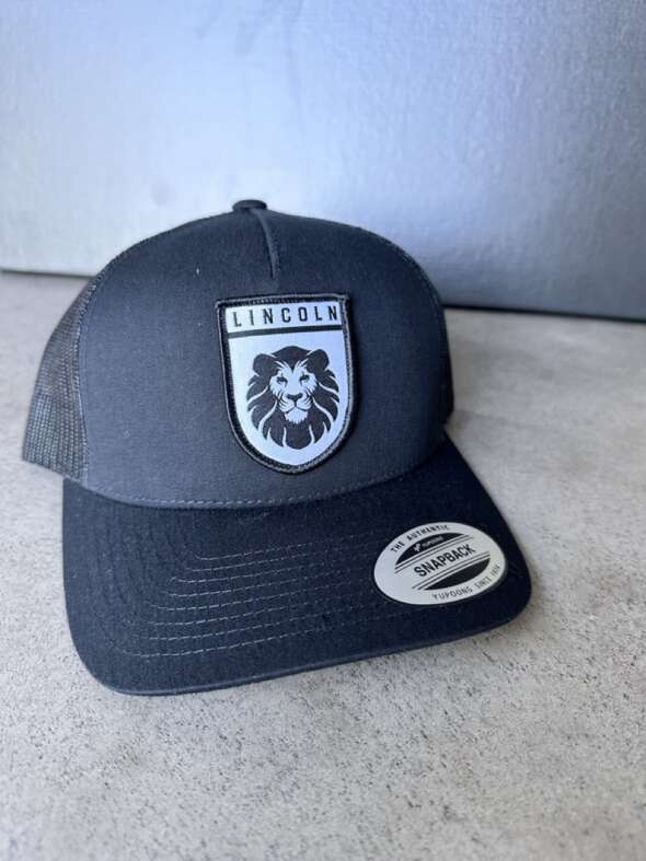 Black Trucker Hat with Lion Shield