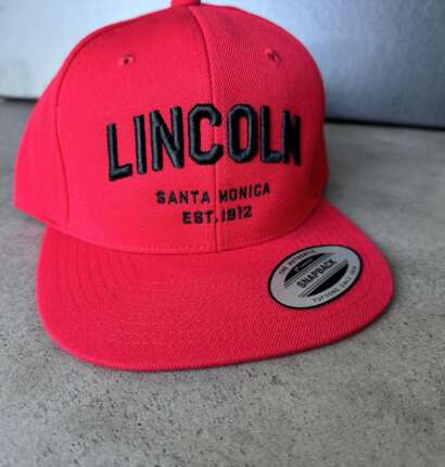 Red Flat Brimmed Hat with Lincoln Wordmark